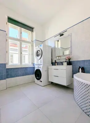 a bathroom with a washing machine and a sink at New Town Studio, free coffee in Prague