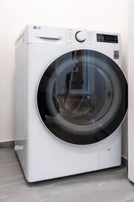 a white washing machine sitting in a room at Contemporary apartment with garage parking in Prague
