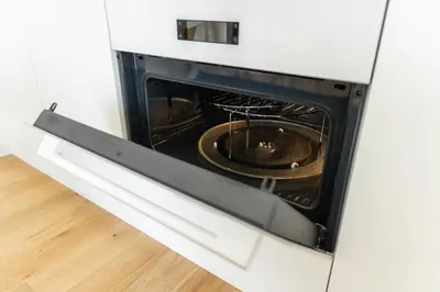 a white oven with a pan inside of it at Contemporary apartment with garage parking in Prague