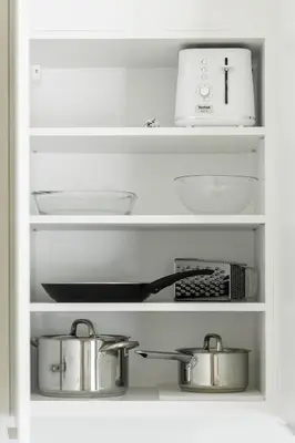 a shelf with pots and pans in a refrigerator at Contemporary apartment with garage parking in Prague