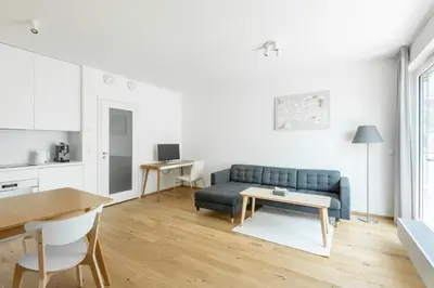 a living room with a blue couch and a table at Contemporary apartment with garage parking in Prague