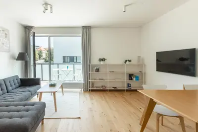 a living room with a couch and a table at Contemporary apartment with garage parking in Prague