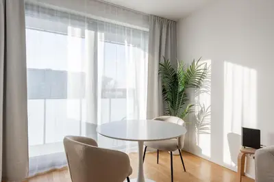 a dining room with a table and chairs and a window at Cool All-in Apartment Prague in Prague