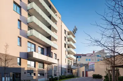 an apartment building with balconies on a street at Cool All-in Apartment Prague in Prague