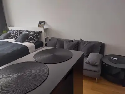 a living room with a couch and a table at Комфортная, уютная,романтичная in Prague