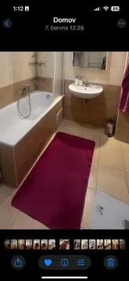 a bathroom with a bath tub and a sink at Štepánská 3 in Prague