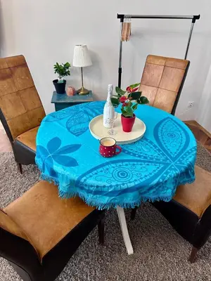 a table with a blue table cloth on it with two chairs at Štepánská 3 in Prague