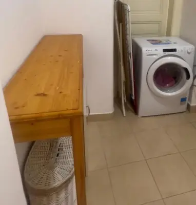 a laundry room with a washing machine and a table at Štepánská 3 in Prague