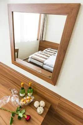 a mirror on a wall above a table with food and drinks at Hotel u Ledu in Velké Popovice