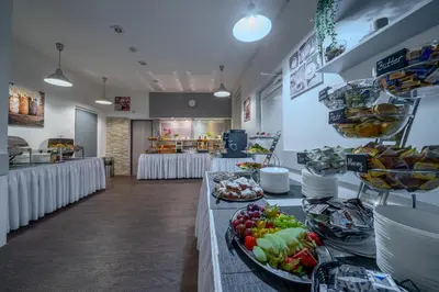 a buffet line with plates of food in a restaurant at Hotel u Ledu in Velké Popovice