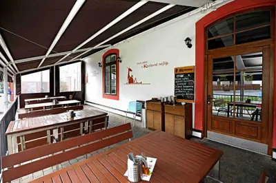 a restaurant with benches and a chalkboard on the wall at Hotel u Ledu in Velké Popovice