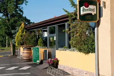 a restaurant with a sign on the side of a building at Hotel u Ledu in Velké Popovice