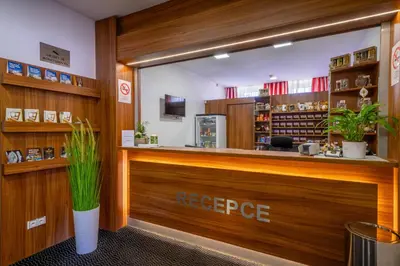 a restaurant with a reception counter with a repurchase at Hotel u Ledu in Velké Popovice