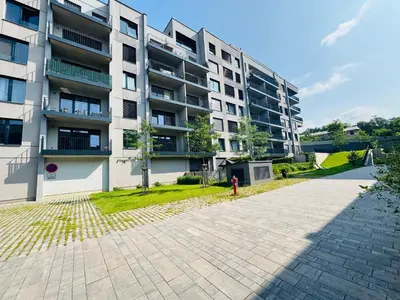 a person standing in front of a apartment building at Lengo Apartment Smichov in Prague