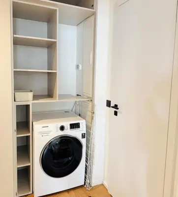 a laundry room with a washer and dryer at Lengo Apartment Smichov in Prague
