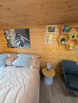 a room with two chairs and a refrigerator at Bee house