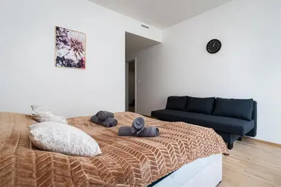 a bedroom with a bed and a blue couch at Elvis Deluxe Suite in Prague