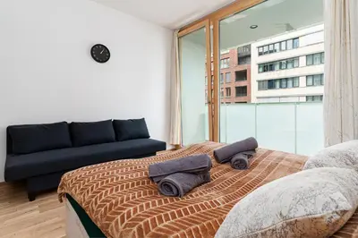 a bedroom with a bed with two towels on it at Elvis Deluxe Suite in Prague