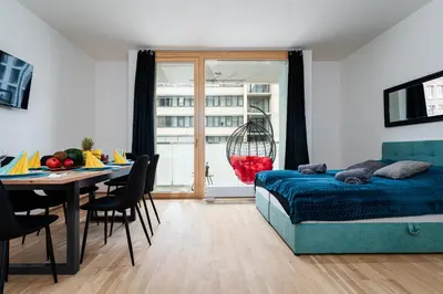 a bedroom with a bed and a table and a dining room at Elvis Deluxe Suite in Prague