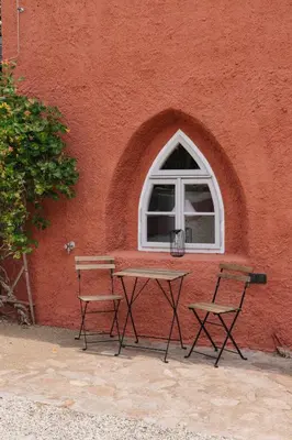 a table and two chairs in front of a window at Zámecká Stodola - Červený Hrádek u Sedlčan in Sedlčany