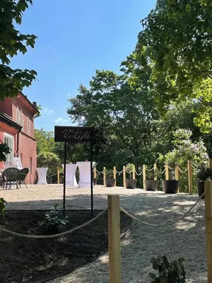 a sign in the middle of a yard with plants at Zámecká Stodola - Červený Hrádek u Sedlčan in Sedlčany