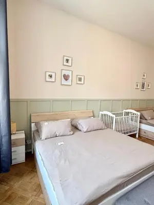 a bedroom with a bed and two cribs at FREE PARKING- 2BDR Apartment in Wenceslas Square in Prague