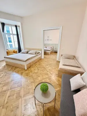 a living room with two beds and a mirror at FREE PARKING- 2BDR Apartment in Wenceslas Square in Prague