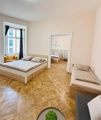 a bedroom with two beds and a mirror at FREE PARKING- 2BDR Apartment in Wenceslas Square in Prague