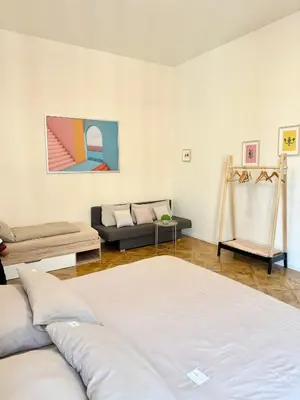 a living room with a bed and a couch at FREE PARKING- 2BDR Apartment in Wenceslas Square in Prague
