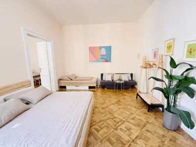 a white room with a bed and a potted plant at FREE PARKING- 2BDR Apartment in Wenceslas Square in Prague