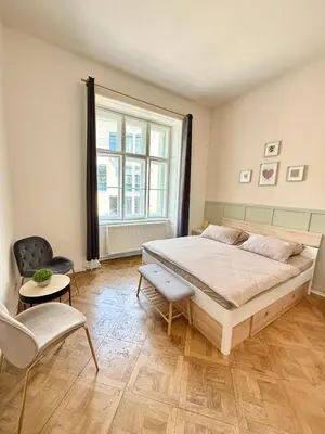 a bedroom with a large bed and a window at FREE PARKING- 2BDR Apartment in Wenceslas Square in Prague