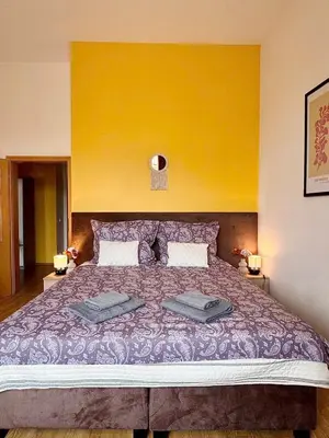 a bedroom with a large bed with two pillows on it at Lumi Retreat Prague in Prague