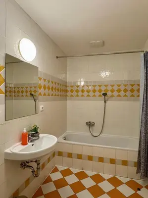 a bathroom with a tub and a sink and a mirror at Lumi Retreat Prague in Prague