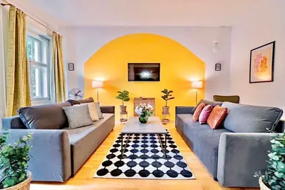a living room with two couches and a fireplace at Lumi Retreat Prague in Prague