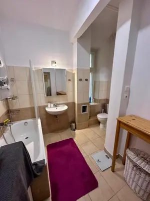 a bathroom with a tub and a sink and a toilet at Štěpánská in Prague