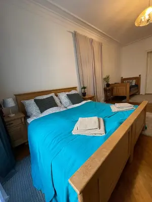 a bedroom with a large bed with blue sheets at Štěpánská in Prague