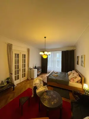 a living room with a bed and a table at Štěpánská in Prague