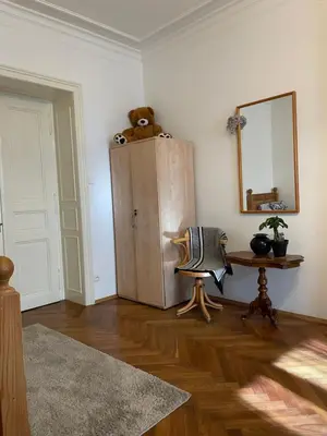 a living room with a teddy bear sitting on top of a cabinet at Štěpánská in Prague