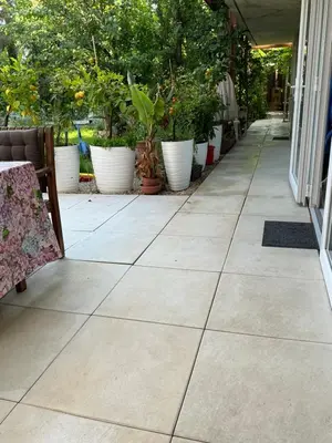 a tile patio with potted plants in pots at Apartmány na náměstí - Kounice in Kounice