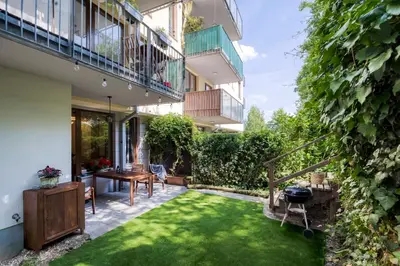 a garden with a small lawn in front of a building at Apartment with garden in Prague 6 in Prague
