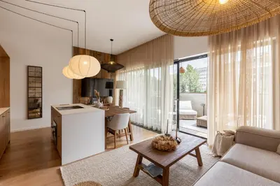 a kitchen and living room with a table and a couch at Dock by STING Hotels in Prague