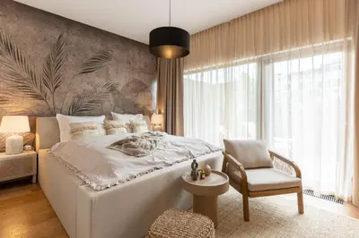 a bedroom with a white bed and a chair at Dock by STING Hotels in Prague