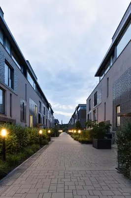 an empty alley between two buildings with street lights at Dock by STING Hotels in Prague
