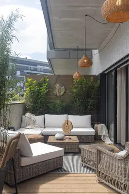 a patio with couches and chairs on a balcony at Dock by STING Hotels in Prague