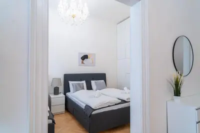 a bedroom with a bed and a mirror at Crystal Apartment in Center of Prague in Prague
