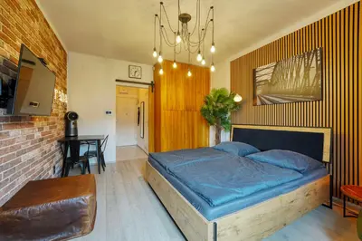 a bedroom with a bed and a table in it at Modern Industry Studio in Prague