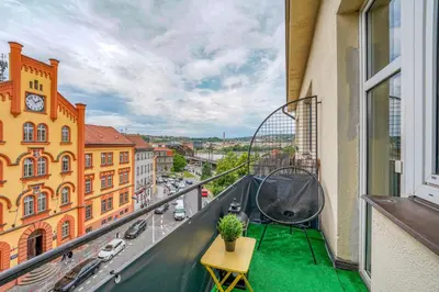 an apartment balcony with a green floor and a table at Modern Industry Studio in Prague