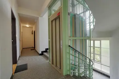 a hallway with a green door in a building at Modern Industry Studio in Prague