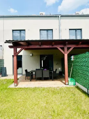 a pavilion with a table and chairs in front of a building at Villa many separate rooms with Free Parking Praha 4 libuš in Prague