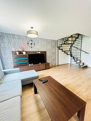 a living room with a couch and a table at Villa many separate rooms with Free Parking Praha 4 libuš in Prague